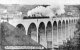 A passenger train heads over Calstock viaduct towards Bere Alston on the opening day of the line, 2nd March 1908. The locomotive is the PD&SWJR 0-6-0 tank 'A.S. Harris'.