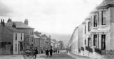 A view down the main street, Gunnislake, circa 1888, with a street vendor's cart in the foreground. Photo by SJ Govier