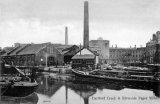 A view of Dartford Creek, near the mouth of the River Darenth, with various barges moored and the Riverside Paper mills behind, circa 1906