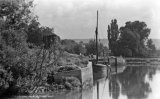 The Aylesford Sand Co. Ltd's quay on the River Medway near Aylesford circa 1925. Thames sailing barge moored alongside