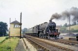 Black Five 4-6-0 No. 44944 leaves Cole, watched by the signalman in his box, with the 4.16pm Evercreech-Templecombe train on 13th July 1962