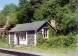 The waiting shelter on the southbound platform at Lampeter station in June 1974. Note: Photo taken with a 110 camera. The neg has deteriorated beyond use and the print is on a mottled surface photo paper, so this scan is the best we can achieve.