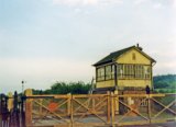 Sarnau Signal Box and level crossing, west of Carmarthen, in June 1974. Note: Photo taken with a 110 camera. The neg has deteriorated beyond use and the print is on a mottled surface photo paper, so this scan is the best we can achieve.