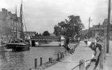 A view of an unidentified waterway & sailing barge c1930. Town centre location, possibly eastern England.