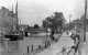 A view of an unidentified waterway & sailing barge c1930. Town centre location, possibly eastern England.