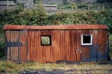 This is part of a survey of Penmaenpool station comprising 56 shots all taken c1970, after the track had been lifted but before any of the major structures had been demolished. Today, the signal box remains as an RSPB observation and information post, whilst the station building has been rendered, painted white and is now a private dwelling. All other structures were demolished circa 1976, whilst the original bracket signal seen in some of these photos adjacent to the George Hotel has been replaced by a more modern tubular post signal. This survey, including many detail shots, would be most useful for anyone wishing to make a model of this station. The GWR line from Ruabon and Bala Junction made an end on junction with the Cambrian Railways Dolgelley Branch at Dolgelley but the Cambrian sited their engine shed here at Penmaenpool.