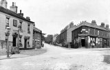 Edwardian view of Stockport Road, Marple, circa 1905, with the Jolly Sailor Hotel on the left and Latham's general stores on the right. Nice signpost and gas lamp on left