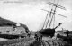 Sidings of the narrow gauge Pentewan Railway at the harbour circa 1905, with a 3-masted sailing ship behind. 